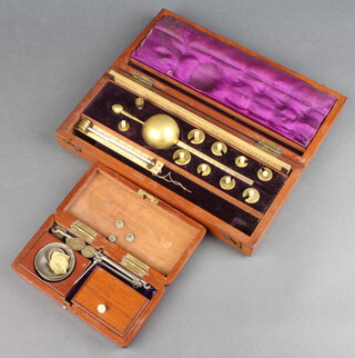 A Sykes hydrometer contained in a mahogany case, together with an apothecary's polished steel hand scales with steel pans and brass weights contained in a wooden case  