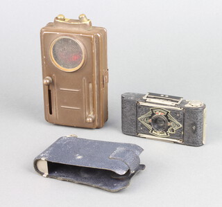 An Ensign Midget folding camera together with a military issue signalling torch, the back marked D.B Ltd L.E no.4 