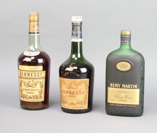 A 1970's bottle of Hennessy VSOP Reserve cognac (low in neck), a 1960's bottle of Hennessy Full Quart cognac (slightly low in neck) and a bottle of Remy Martin fine champagne cognac (slightly low in neck) 