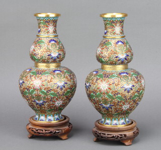 A pair of Japanese cloisonne enamelled double gourd shaped vases raised on pierced hardwood stands 22.5cm h x 10cm 