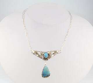 An Art Nouveau style silver and opal drop pendant with leaf decoration 
