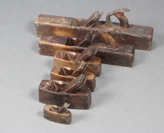 Two wooden shooting/jack planes together with 4 smoothing planes