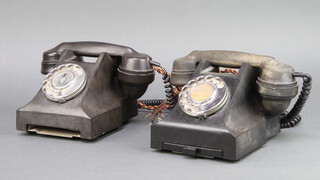 A black Bakelite dial telephone the base marked 332L Pl57/2A and 1 other dial telephone marked 332L E2 (slide to base missing) 