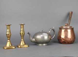 A pair of 18th/19th Century brass candlesticks with ejectors 19cm, a 19th Century circular copper saucepan and cover with iron handle 16cm x 15cm (some dents) and a Britannia metal teapot 