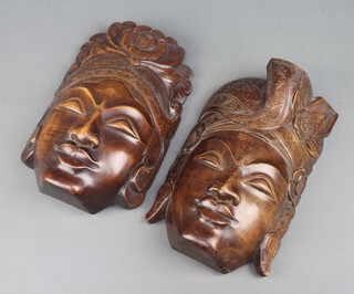 A pair of Bali carved hardwood masks 30cm x 18cm 