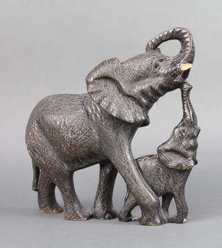 An African carved hardstone figure of a standing elephant and calf 21cm h x 25cm w x 9cm d 