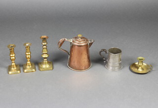 A copper waisted jug with brass finial 18cm x 14cm, a pair of 19th Century brass candlesticks 17cm, 1 other candlestick, brass chamber stick and a pewter tankard