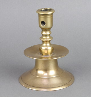 A 17th/18th Century polished bronze bell shaped candlestick raised on a spreading foot 14cm h x 14cm x 10cm 