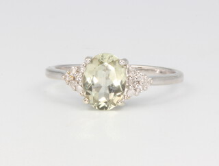 A 9ct yellow gold peridot and diamond ring, 2 grams, size N