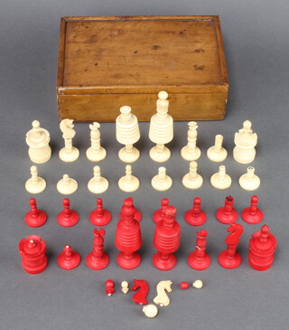 A 19th Century red and white stained and carved bone part chess set 