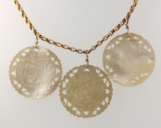 A 9ct yellow gold necklace with 3 carved mother of pearl pendants decorated with figures