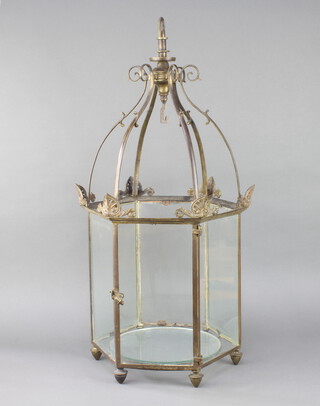 A Regency gilt metal hexagonal hanging hall lantern raised on bun feet with hinged opening door 77cm h x 31cm 