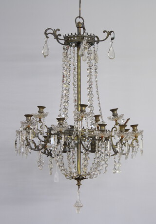 A gilt metal and glass 14 light candle lit chandelier having 2 bulbs to the centre 75cm h x 56cm diam. 