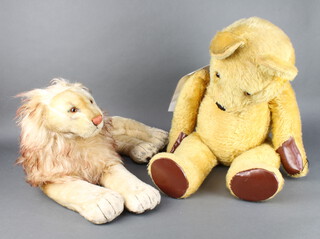 A yellow Steiff bear 84cm (pads have been replaced, the ear stud is missing) together with a lion soft toy 30cm x 61cm x 42cm  