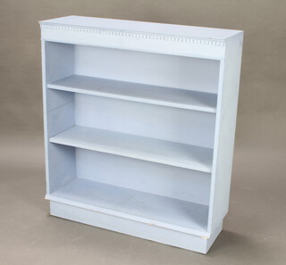 A blue painted bookcase with moulded and dentil cornice and adjustable shelves 102cm h x 91cm w x 30cm d 