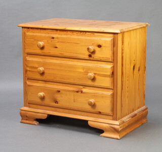 A pine chest of 3 long drawers raised on ogee bracket feet 68cm h x 76cm w x 45cm d 