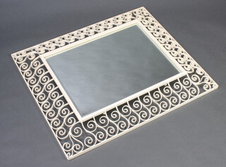 A rectangular shaped plate wall mirror contained in a pierced white painted wrought iron frame 94cm x 77cm 