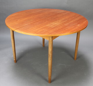 G-Plan, a 1960's oval teak extending dining table with concealed extra leaf, raised on turned supports 72cm h x 100cm 