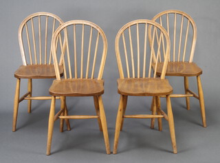 A set of 4 beech and elm stick and hoop back dining chairs with H framed stretchers 