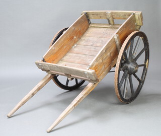 A wooden hand cart with iron shod wheels (signs of old woodworm to one wheel) 76cm wide overall length 158cm 