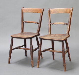 A pair of 19th Century elm bar back Windsor chairs raised on turned supports with H framed stretcher