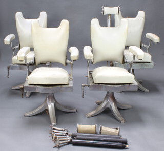 Four 1930's chrome barbers chairs, the seats upholstered in white rexine with headrests and foot rests