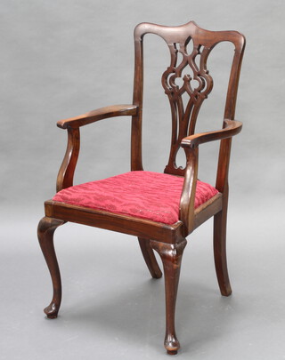 A Chippendale style mahogany carver chair with pierced vase shaped slat back and upholstered drop in seat 