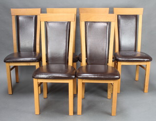 A set of 6 oak high back dining chairs, the seats and backs upholstered in leather 