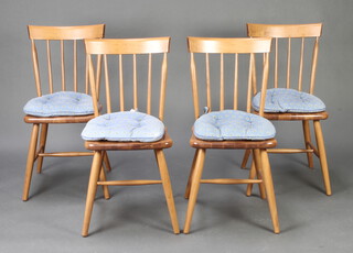 A set of 4 beech framed stick and bar back dining chairs on turned supports with H framed stretcher 