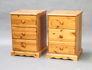 A pair of pine 3 drawer bedside chests with tore handles, on platform bases 62cm h x 42cm w x 43cm d 