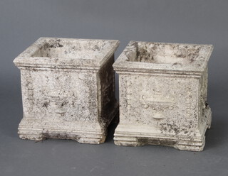 A pair of square reconstituted stone urns decorated with lidded urns and covers and with swag decoration 28cm h x 29cm w x 29cm d 