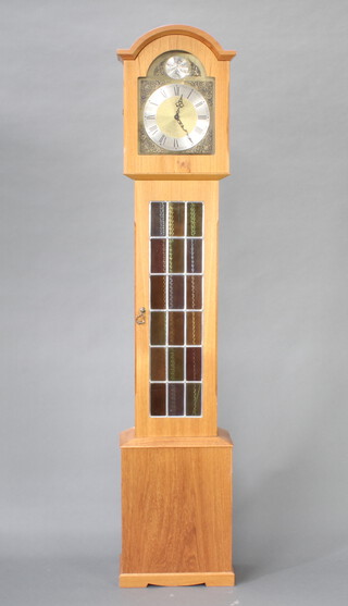 A chiming longcase clock, the 25cm gilt arched dial with Roman numerals, contained in an oak case with weights and pendulum 