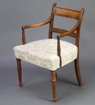A 19th Century mahogany bar back carver chair with plain mid rails and over stuffed seat, raised on turned supports 