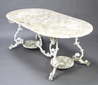 A Victorian style white painted pierced aluminium garden table raised on cabriole supports 71cm h x 97cm w x 184cm l