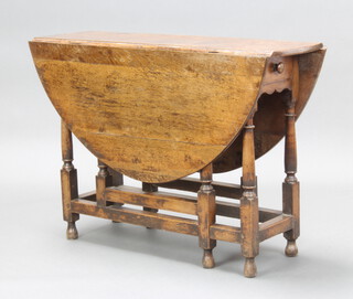 A 17th/18th Century oak oval drop flap gateleg dining table fitted a drawer raised on turned supports 70cm h x 99cm w x 31cm  when closed x 118cm when open  