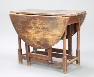 A 17th/18th Century oak drop flap gateleg dining table raised on turned supports 76cm h x 103cm w x 41cm when closed x 130cm when open 
