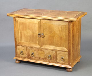 An Art Nouveau style inlaid mango wood cabinet enclosed by double cupboards above 1 long and 2 short drawers, on bun feet 81cm h x 110cm w x 50cm d 