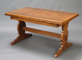 An Ercol elm refectory style drawleaf dining table raised on standard end supports with H framed stretcher 75cm h x 137cm l x 84cm w 