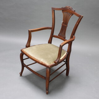 An Edwardian mahogany open armchair upholstered in green material, on cabriole supports 