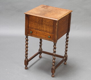 A 1930's square oak sewing box with hinged lid, the base fitted a drawer, raised on spiral turned supports 61cm h x 35cm w x 35cm d 