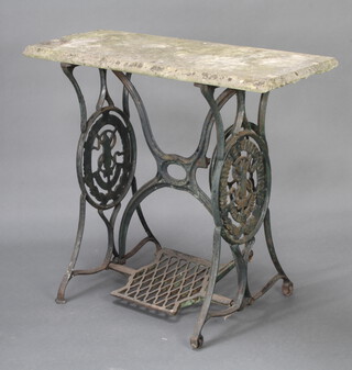 A rectangular garden table with reconstituted stone top and treadle sewing machine base 74cm h x 89cm l x 33cm w 
