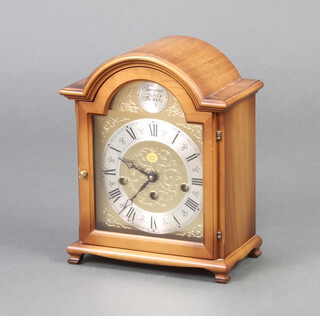 W Haid, a cherry Georgian style bracket clock with arched gilt dial contained in a walnut case 