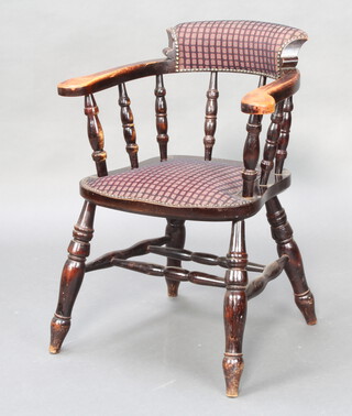 A beech framed smokers bow chair raised on turned supports with double H framed stretcher