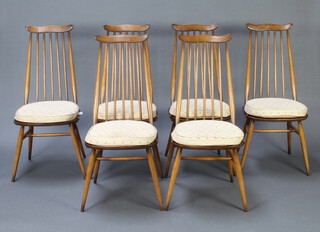 Ercol, a set of 6 beech and elm stick and rail back dining chairs, raised on turned supports with H framed stretchers 
