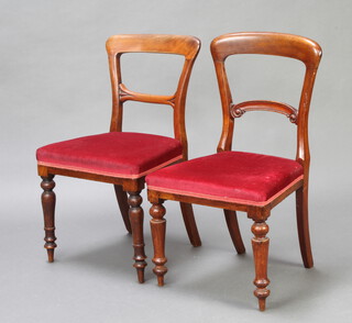 A near pair of Victorian oak spoon back dining chairs with shaped mid rails and overstuffed seats 