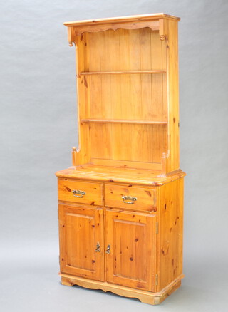A Victorian style pine dresser, the raised back fitted 2 shelves, the base with 2 drawers above double cupboard 190cm h x 85cm w x 44cm d 