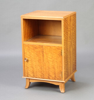 Vesper, a mid Century walnut bedside cabinet with recess above panelled door, raised on shaped supports 65cm h x 39cm w x 34cm d 