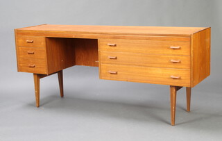A mid Century teak dressing table fitted 3 short and 3 long drawers raised on turned supports 73cm h x 168cm w x 46cm d 