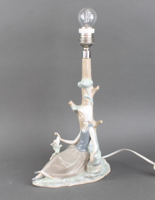 A Lladro table lamp in the form of a seated girl with doves base marked Lladro 33cm h x 11cm x 29cm 