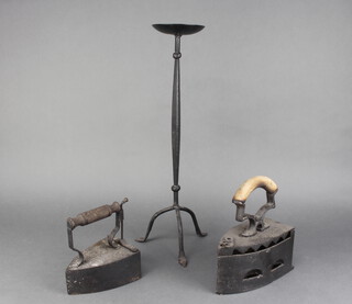 Two 19th Century box irons (missing slugs) and a wrought iron candle holder